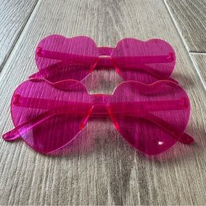 Two pairs of pink heart shaped glasses